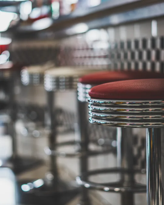 Red stools alongside the diner counter