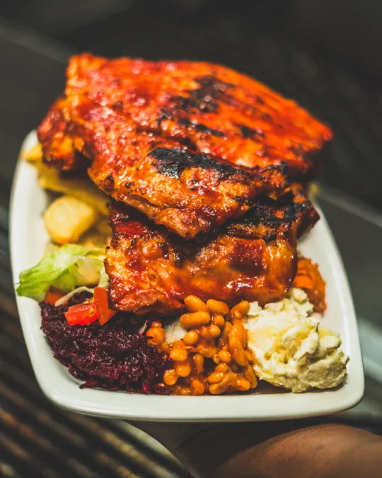 A platter of ribs and sides