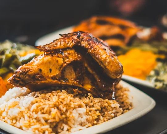 Roast chicken served with rice and vegetables