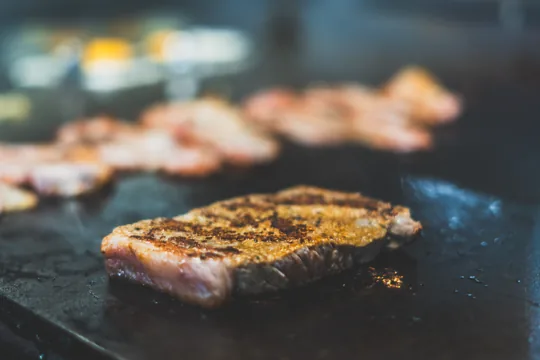 Meat sizzling on the flat-top grill