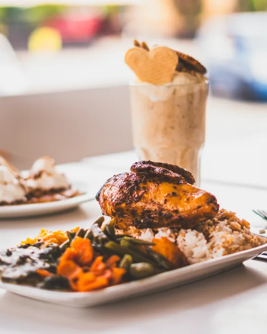 A meal and milkshake on the table