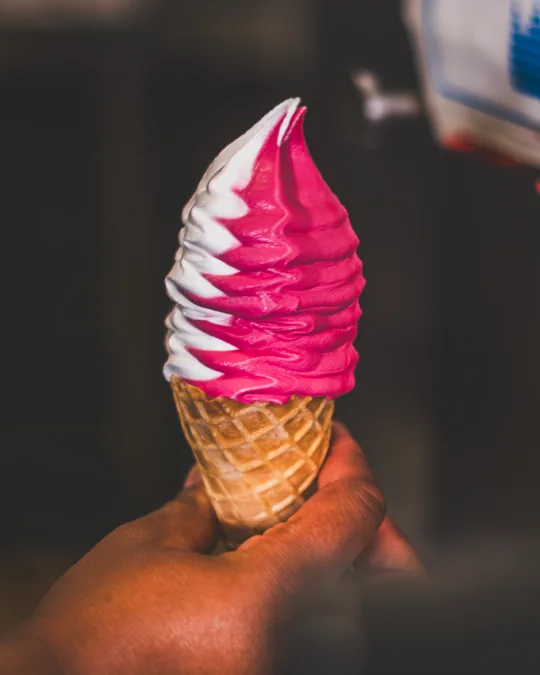 Pink soft-serve ice cream cone